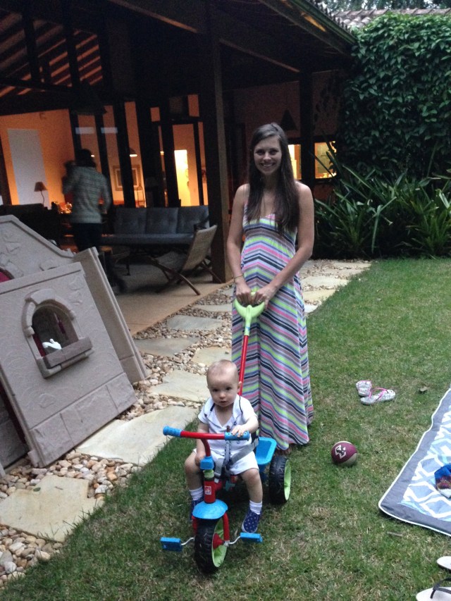 Paige pushing Colt around the yard