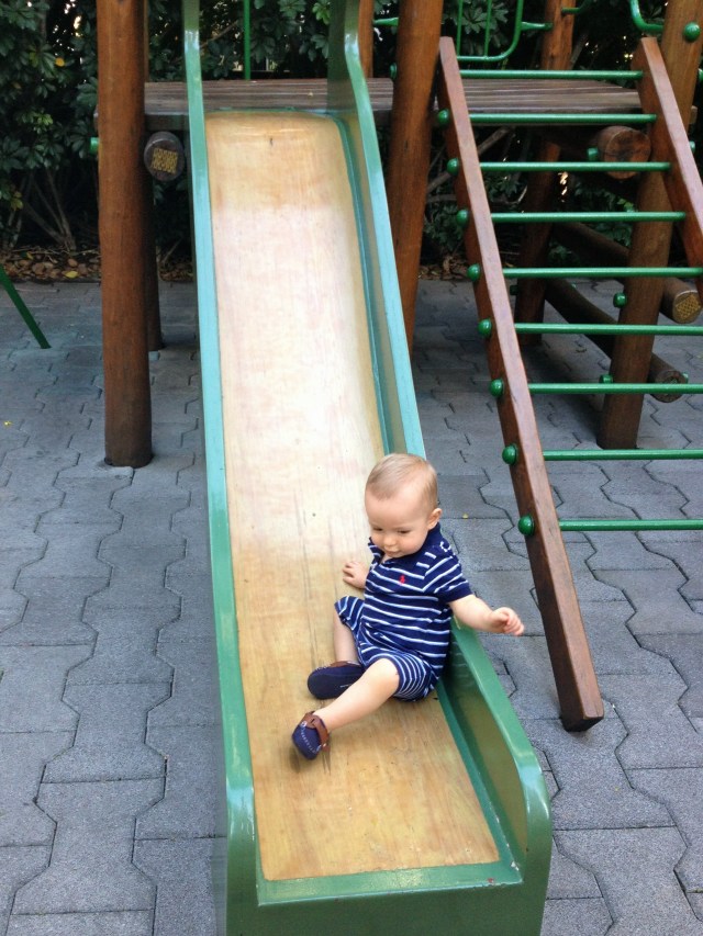 Colt always climbs onto the slide and tries to walk up as far as he can.