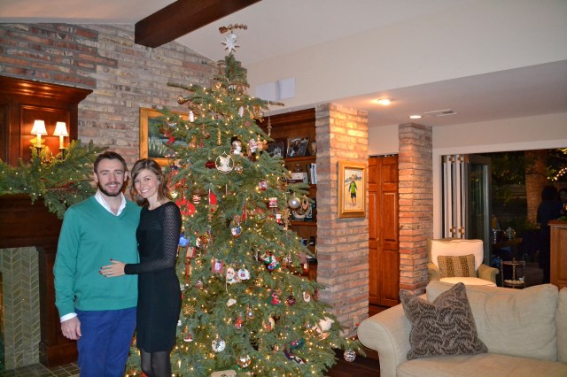 In front of the tree.