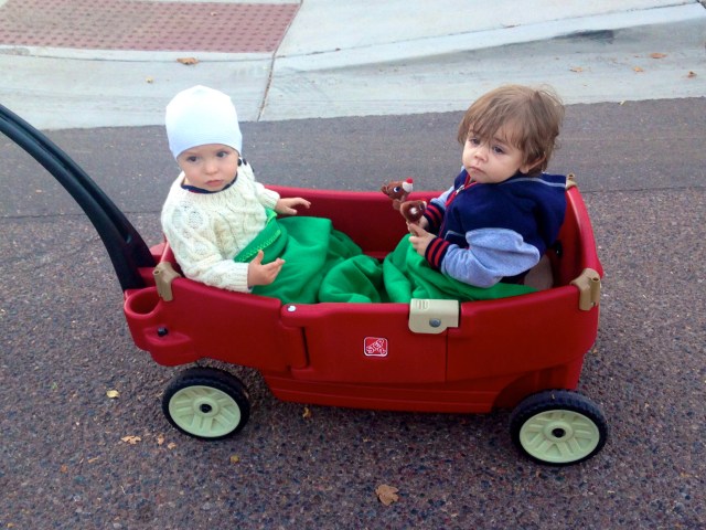 JJ and Colt (wearing a hat that officially looks like a swim cap) riding along in the wagon.