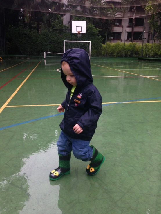 Splishing and splashing in the rain! Loving the boots from his godparents Mike & Mo!