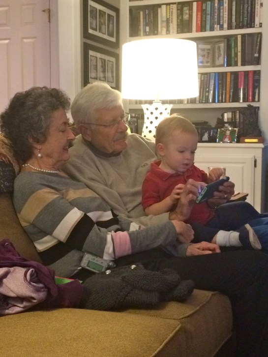 Flipping through pictures with Nannie and Papa.