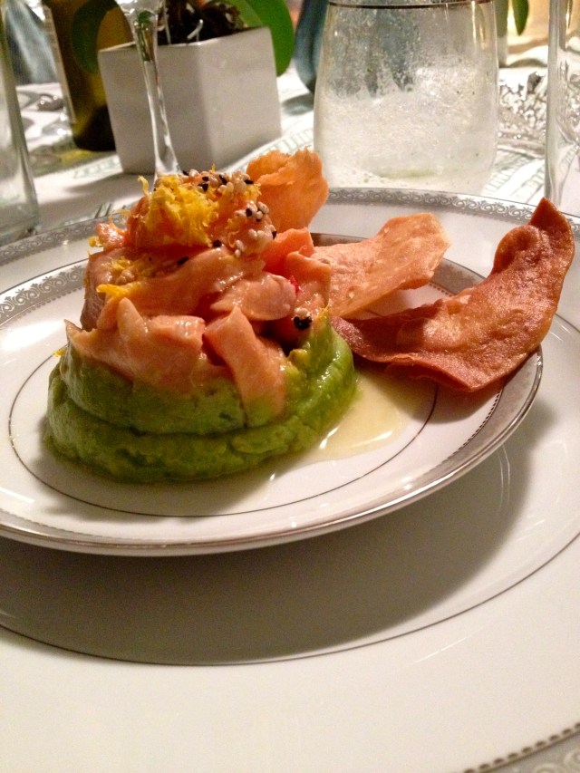 Course 1: salmon ceviche on top of avocado with pita chips.