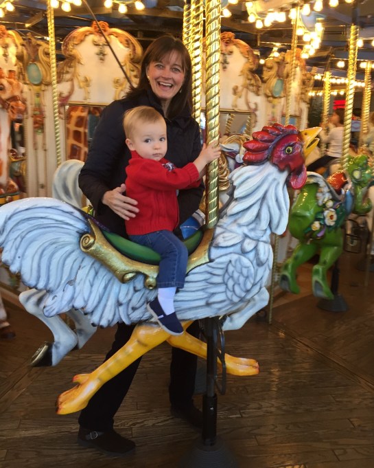 Gigi and Colt on the merry-go-round.