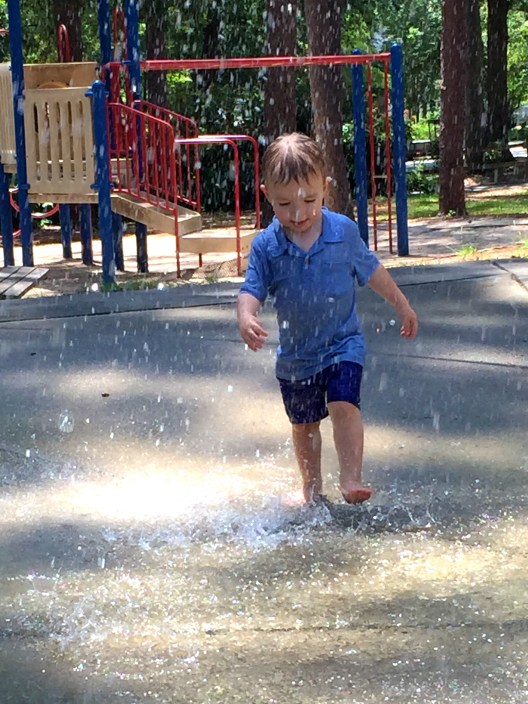 It took a couple visits to the park before he would go totally under the sprinkler solo but once he did, there was no turning back!