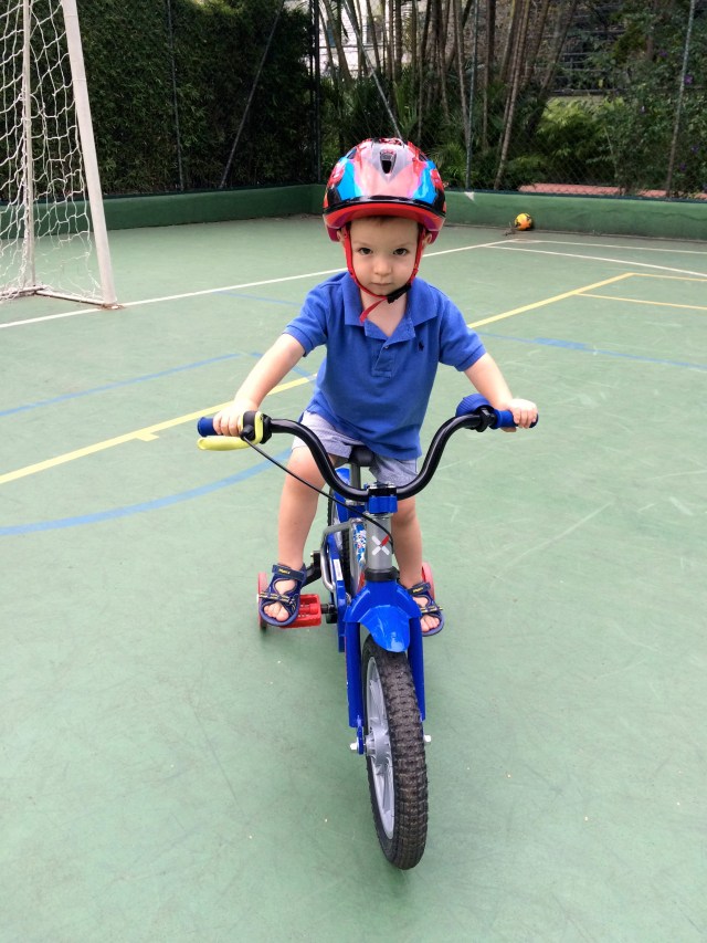 Riding a bike! He could honestly do this allllll day long.