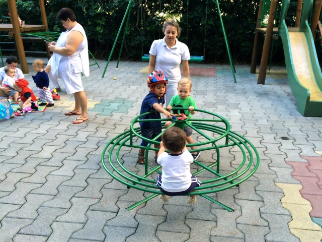 Playing with friends (and nannies) in our apartment complex.